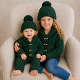 Girl and baby on cream chair wear green Rocky crochet cardigans and hats; baby wears matching pants. Digital pattern PDF set.