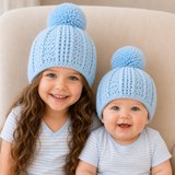 Older girl and baby on a cream chair wear pale blue Zeb crochet beanies. Digital pattern PDF, sizes Preemie to 10 Years.