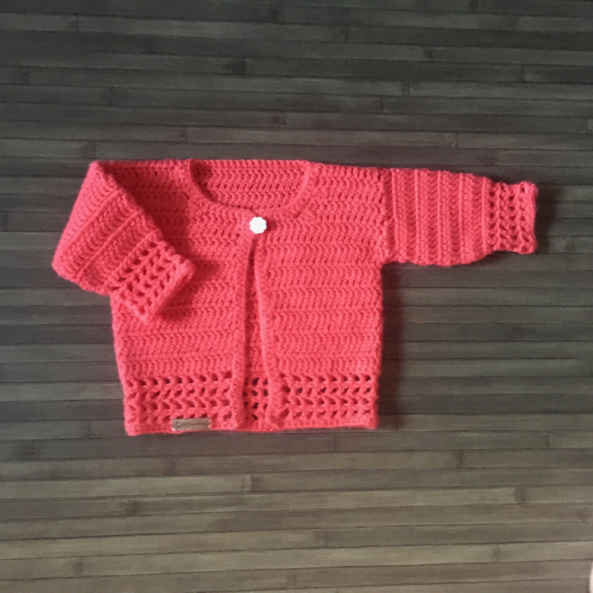 Coral Crochet Baby Sweater one arm in