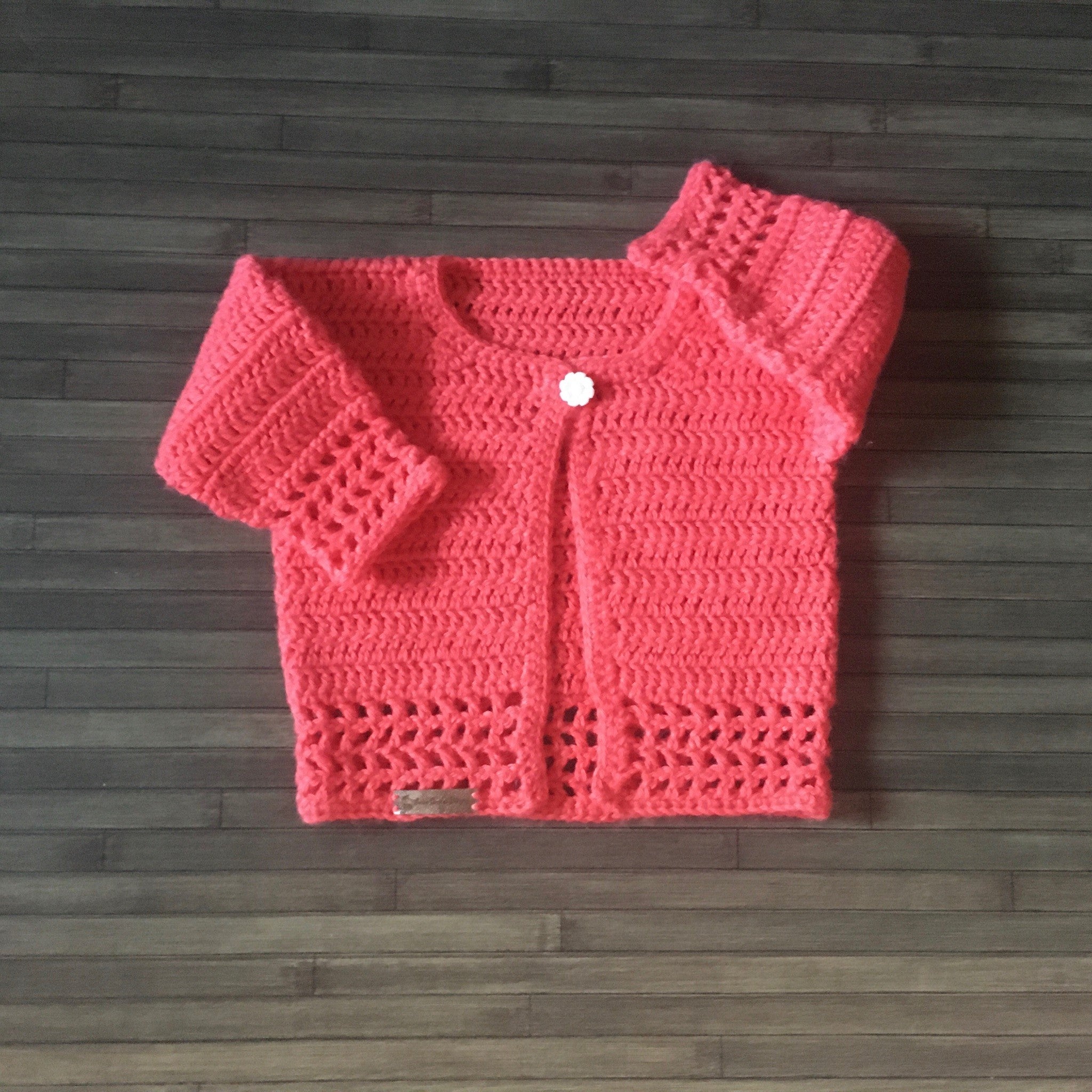 Coral baby sweater one arm up one arm down