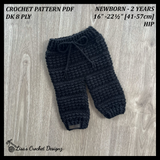 Black Aaron crochet baby pants flat lay on light gray wood, showing digital pattern PDF details, sizes Newborn to 2 Years.