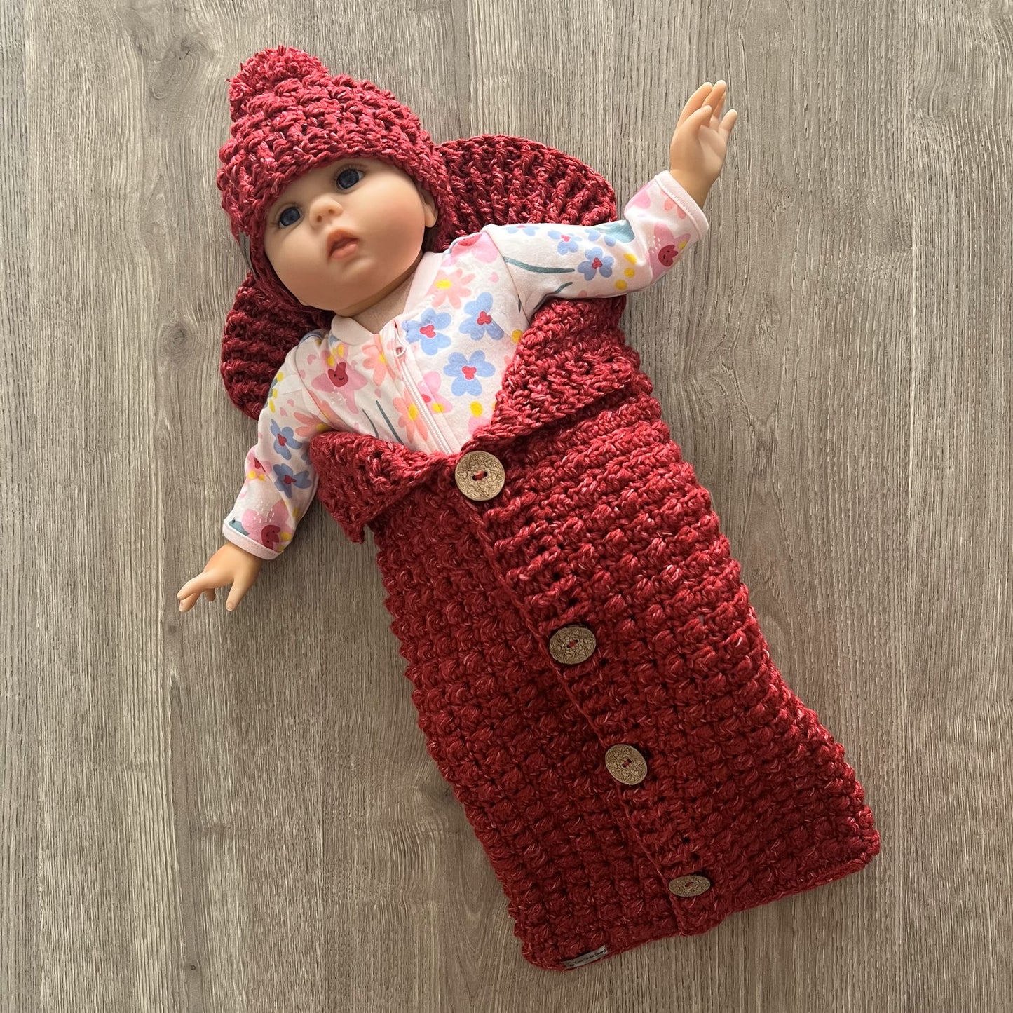 berri crochet baby sleeping bag with baby inside wearing hat