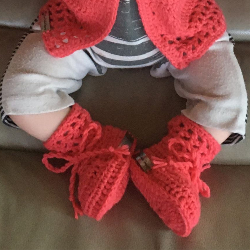 coral sweater hat and booties on baby