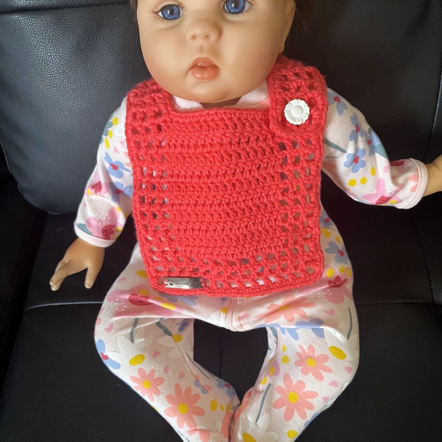 coral baby bib on baby