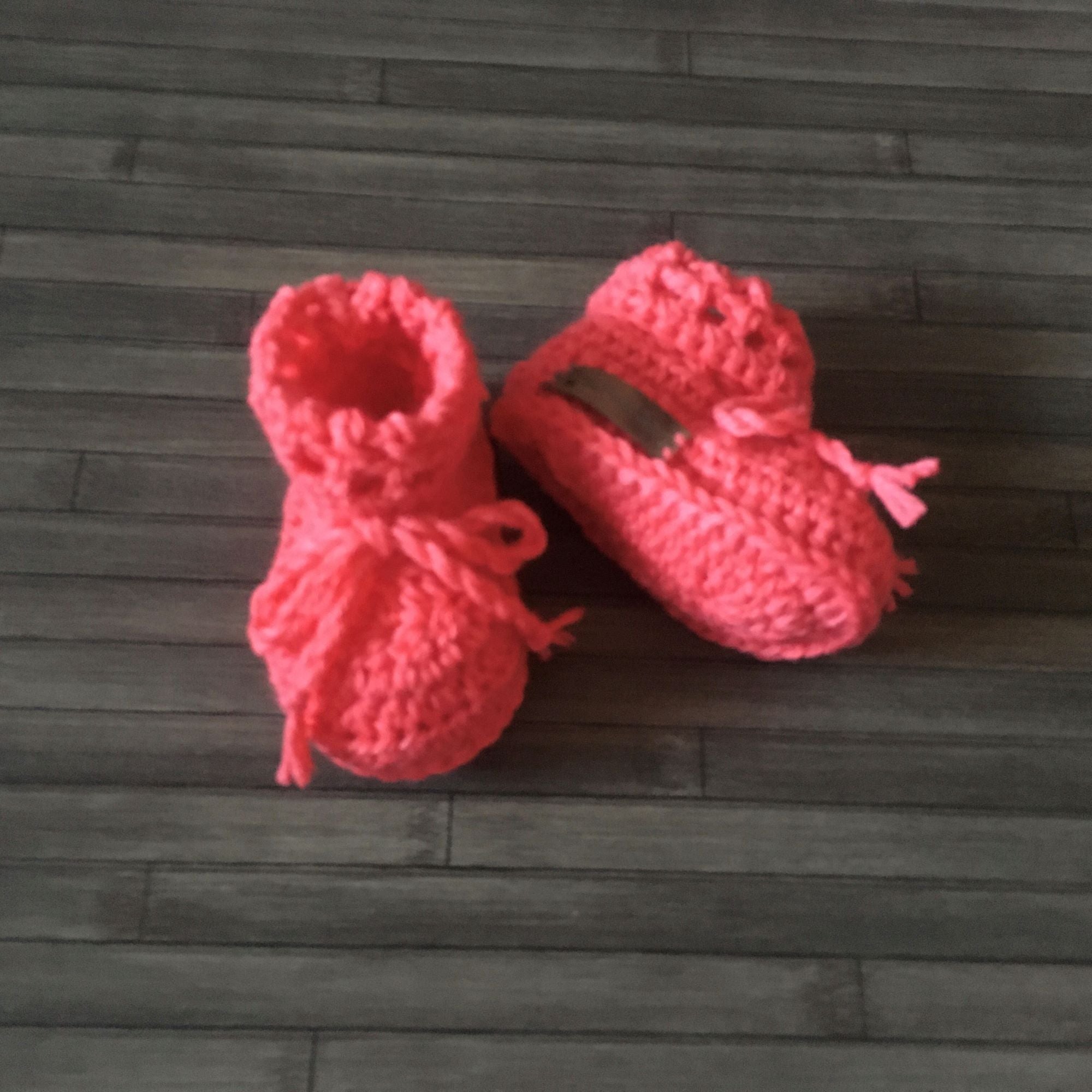 Coral Crochet Baby Booties one bootie lying down