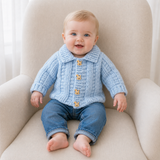 Baby in blue jeans wears a blue Zeb collared crochet cardigan on a cream chair. Digital pattern PDF, sizes 0 to 2 Years.
