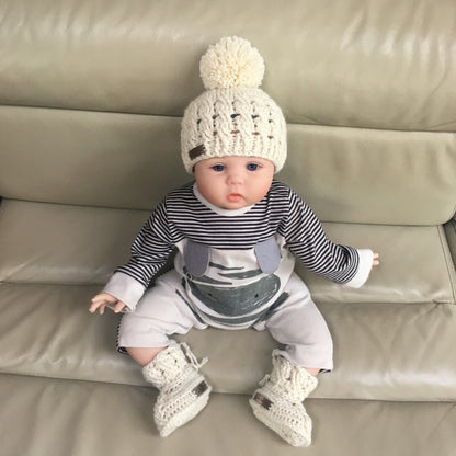 caleb crochet cabled hat and booties on baby